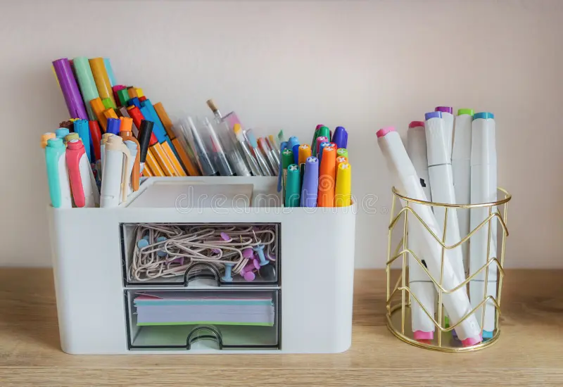 close up organized office stationery including various multi colored felt tip pens professional art markers small desktop 439933534
